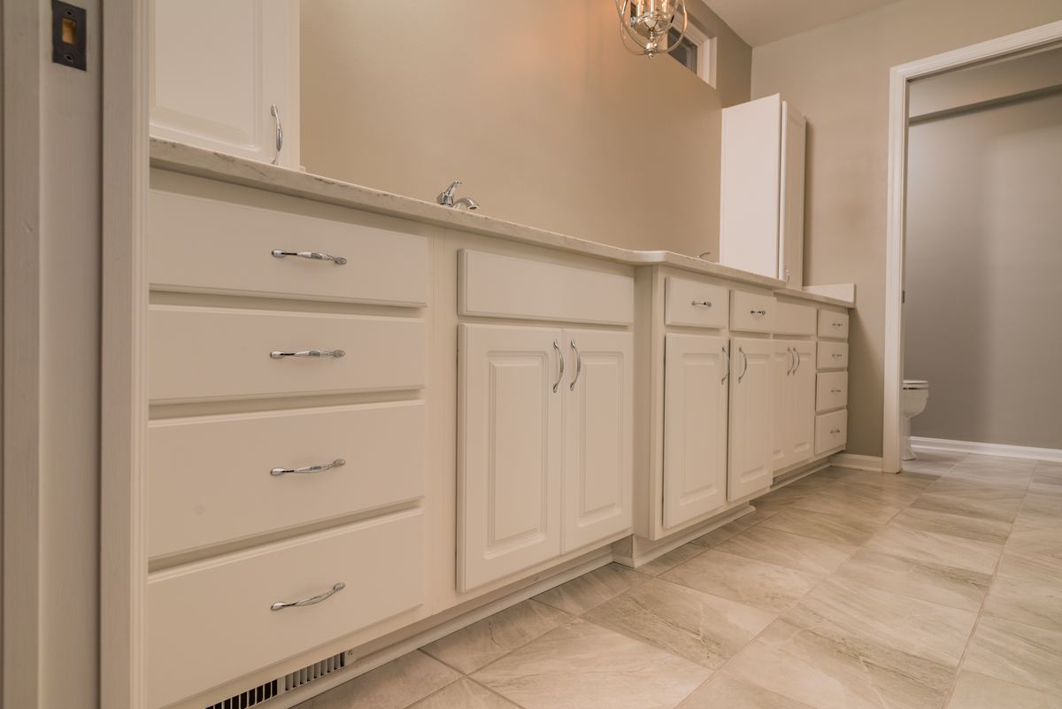 Double vanity with stone top and full drawer bank in a remodeled bathroom